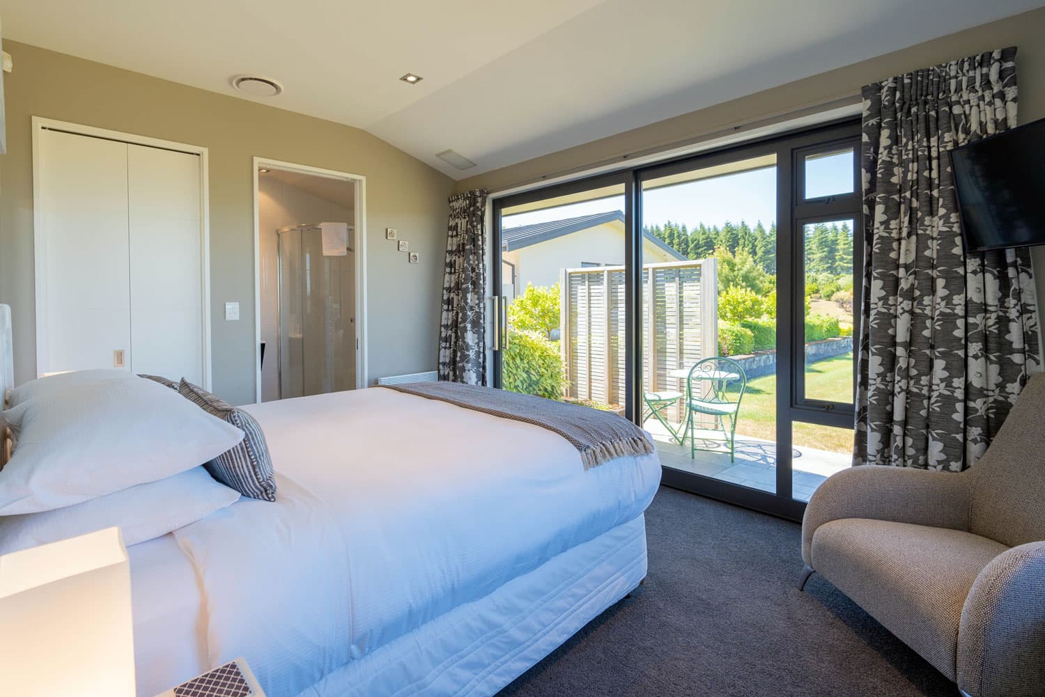 The Takitimu Room at High Leys Lodge Te Anau is warm, light and bright and features a private ensuite and lush garden views.
